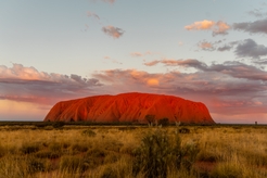 Uluru set amongst an outback sunset